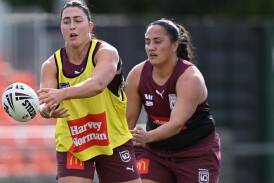 Queensland forward Romy Teitzel (l) emerged from hardship to become a key figure for the Maroons. (Darren England/AAP PHOTOS)
